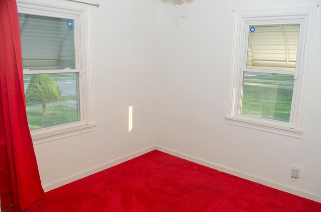 empty room featuring carpet flooring and a healthy amount of sunlight