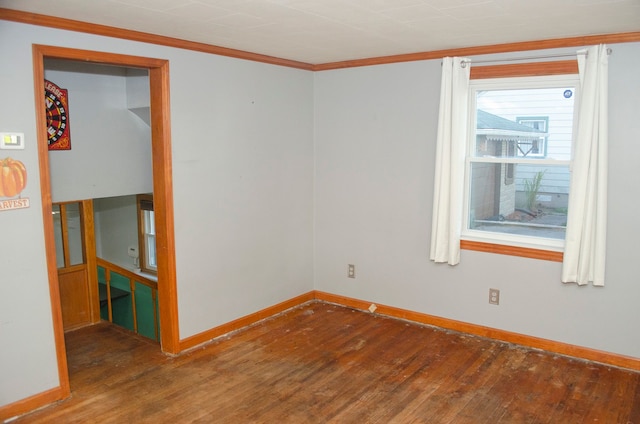 unfurnished room with hardwood / wood-style floors and ornamental molding