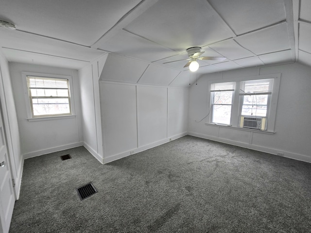 bonus room featuring ceiling fan, lofted ceiling, cooling unit, and dark colored carpet