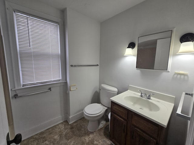 bathroom featuring toilet and vanity