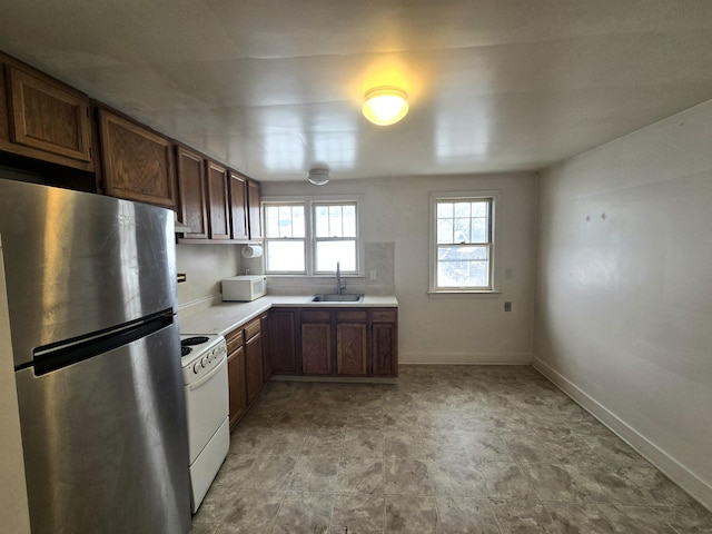 kitchen with backsplash, sink, and white appliances