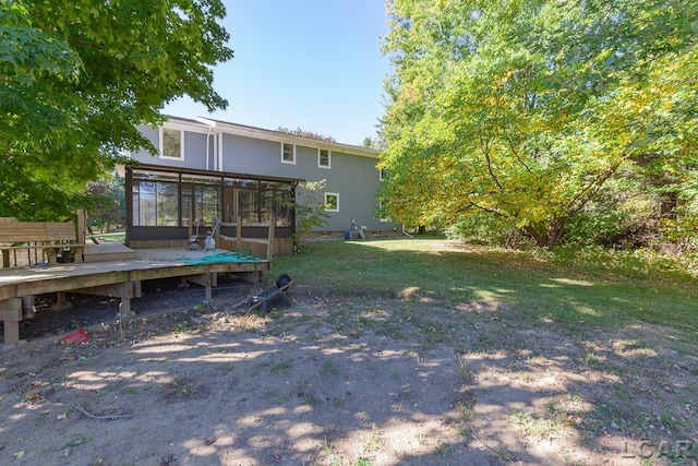 view of yard featuring a wooden deck and a sunroom