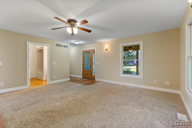 unfurnished room featuring light carpet and ceiling fan