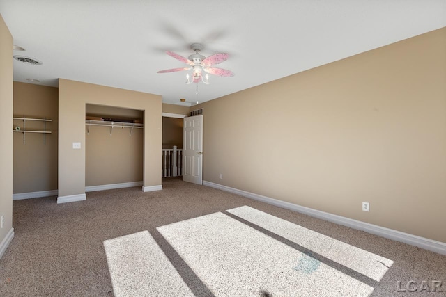 unfurnished bedroom featuring ceiling fan, carpet floors, and a closet