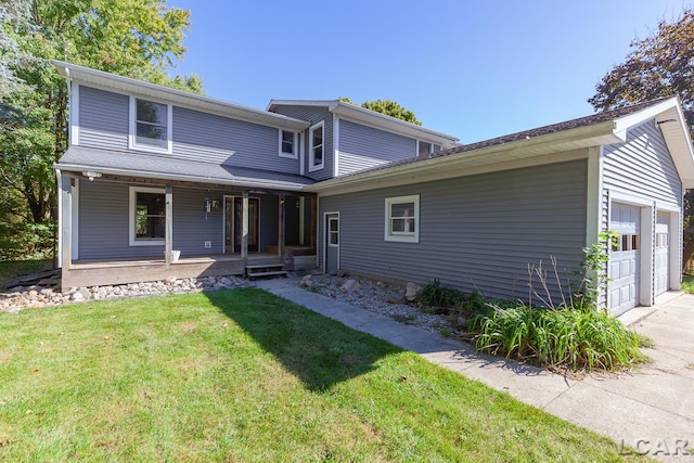 front facade with covered porch, a garage, and a front yard