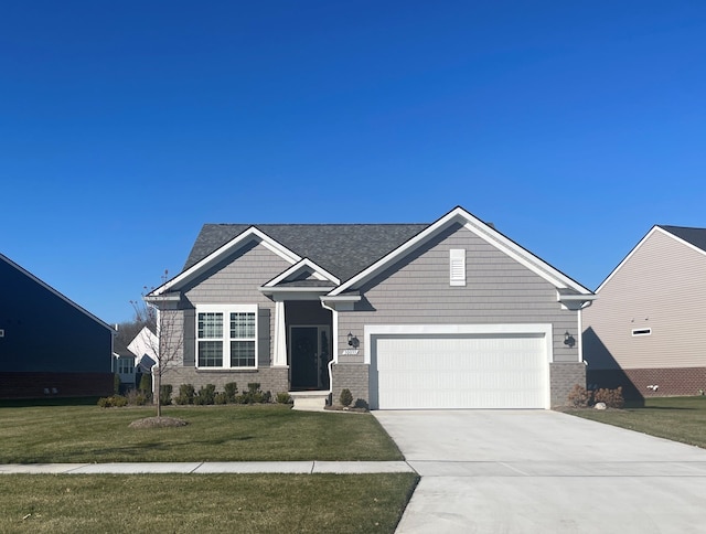 craftsman-style house featuring an attached garage, brick siding, concrete driveway, and a front yard