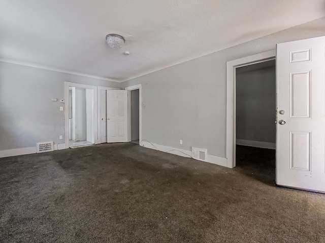 empty room featuring dark colored carpet