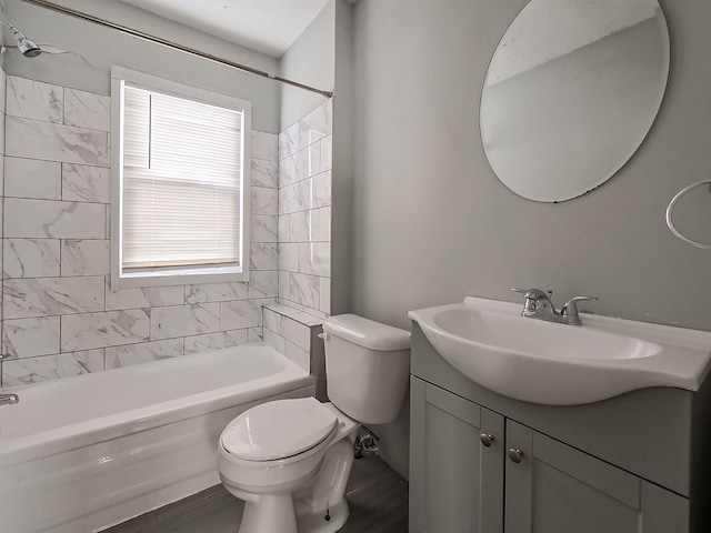 full bathroom featuring wood-type flooring, vanity, toilet, and tiled shower / bath