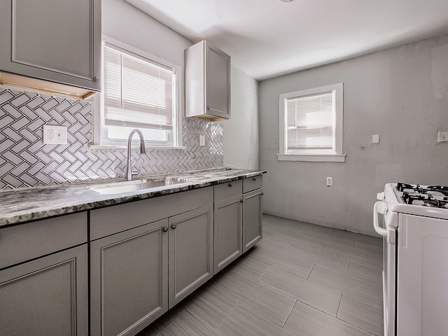 kitchen featuring gray cabinets and a wealth of natural light