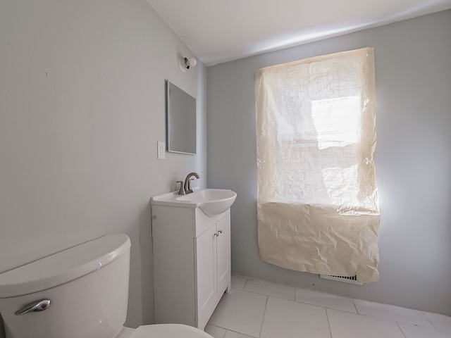 bathroom with tile patterned flooring, vanity, and toilet