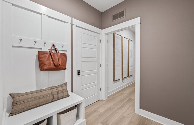 mudroom with light hardwood / wood-style floors