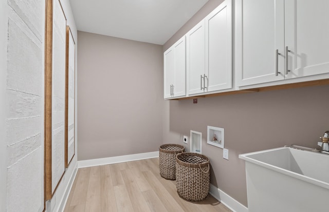 laundry area featuring electric dryer hookup, cabinets, sink, hookup for a washing machine, and light hardwood / wood-style flooring