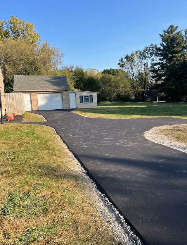 view of front of property with a garage and a front lawn