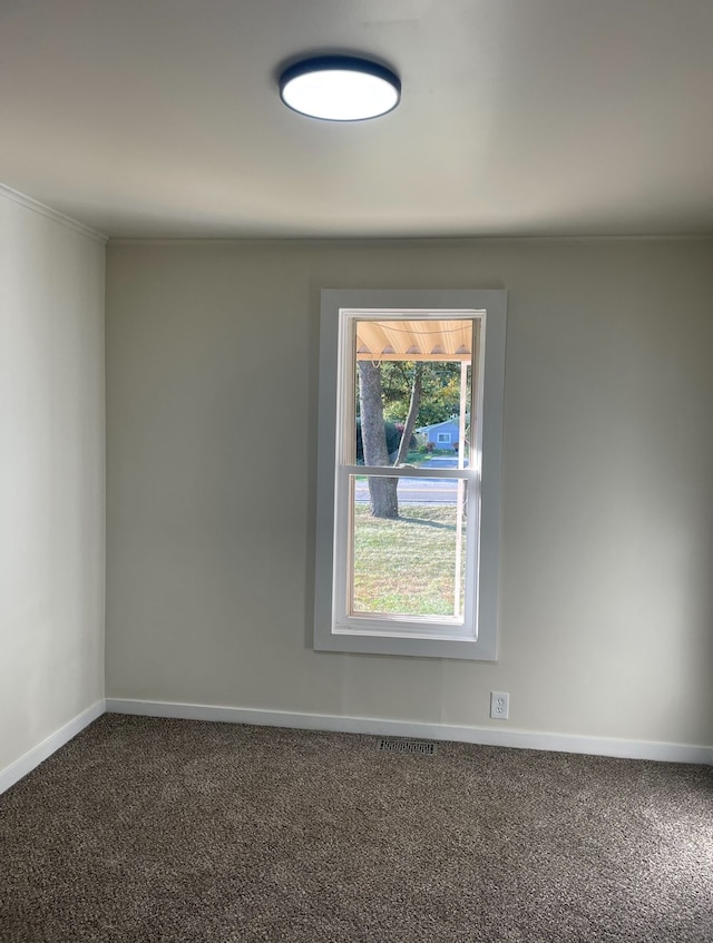 unfurnished room featuring dark colored carpet