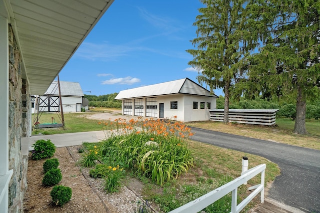 exterior space featuring an outdoor structure and a front yard