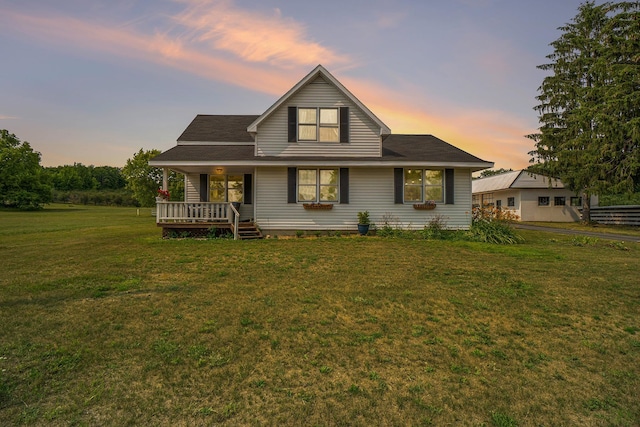 view of front of house featuring covered porch and a yard