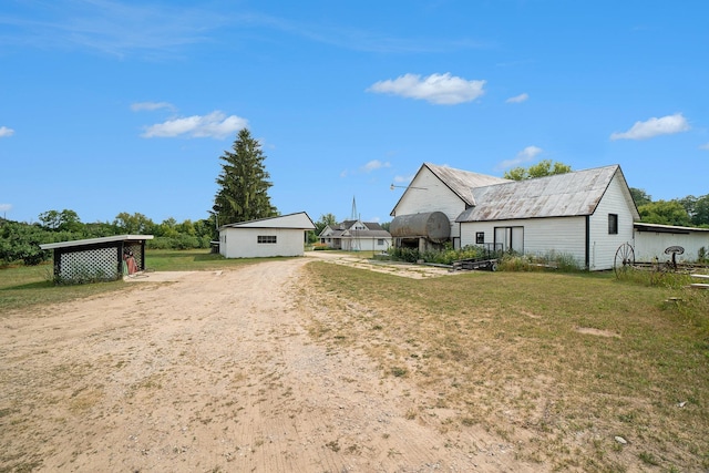 exterior space with an outbuilding and a lawn