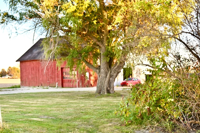 12101 Todd Rd, Ida, MI 48140 - view of green lawn featuring a barn, an outbuilding, and a detached garage