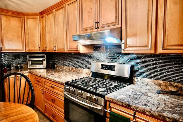 12101 Todd Rd, Ida, MI 48140 - kitchen with gas stove, under cabinet range hood, decorative backsplash, and light stone counters