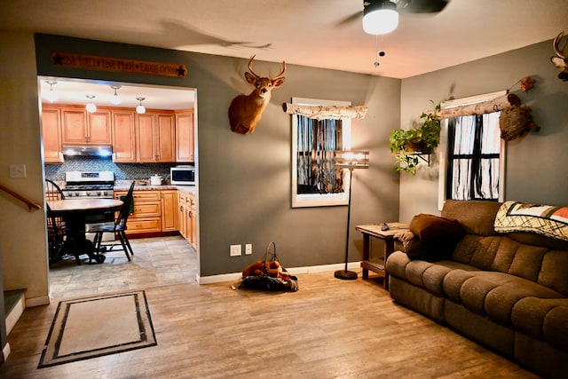 12101 Todd Rd, Ida, MI 48140 - living area featuring baseboards, a ceiling fan, and light wood-style floors