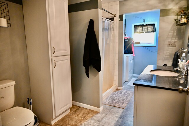 12101 Todd Rd, Ida, MI 48140 - bathroom featuring vanity, washer and dryer, a shower stall, toilet, and baseboards