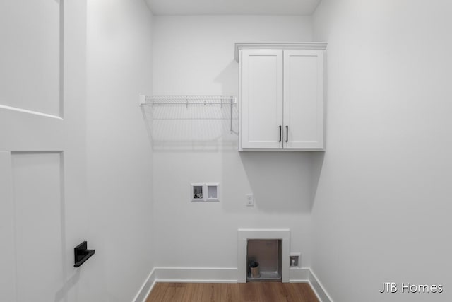 laundry room featuring cabinets, hardwood / wood-style floors, and washer hookup