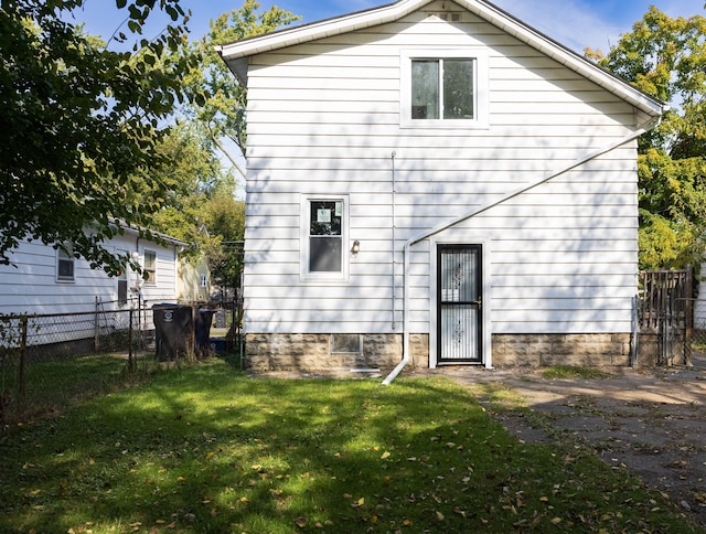 rear view of property with a lawn