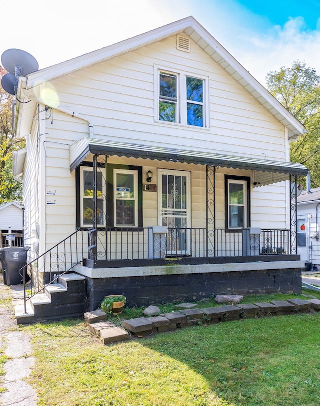 view of front of property with a front yard and a porch