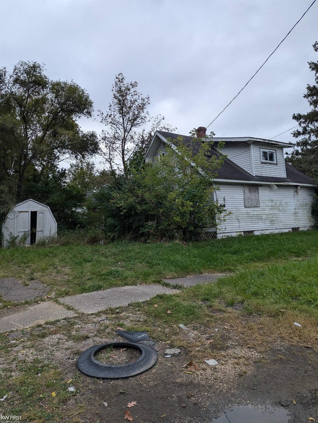 view of side of home featuring a shed