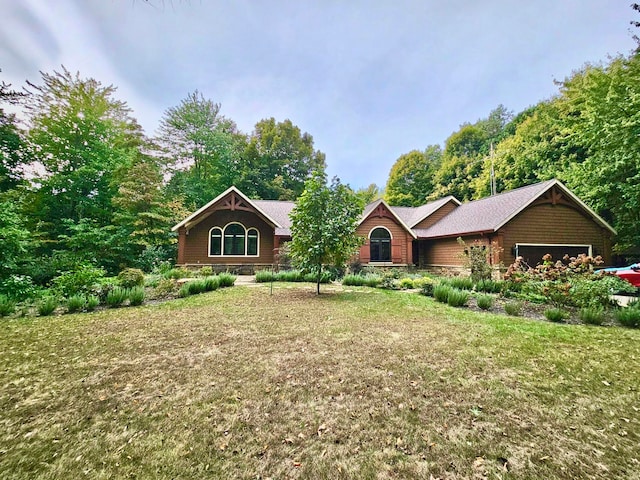 view of front of property with a garage and a front lawn