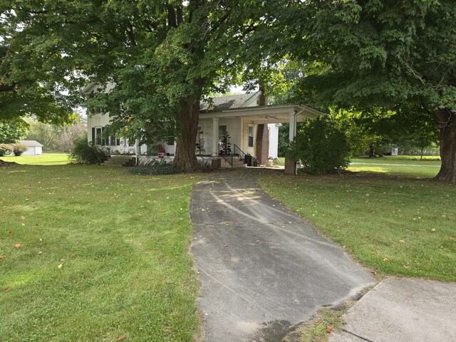 103 S Railroad St, Allen, MI 49227 - view of front of house with a porch, a front yard, driveway, and a chimney