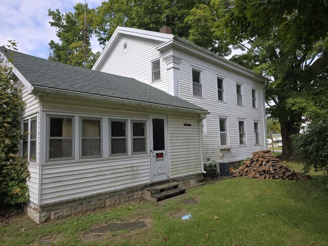 103 S Railroad St, Allen, MI 49227 - view of front of house with entry steps, a shingled roof, a chimney, and a front yard