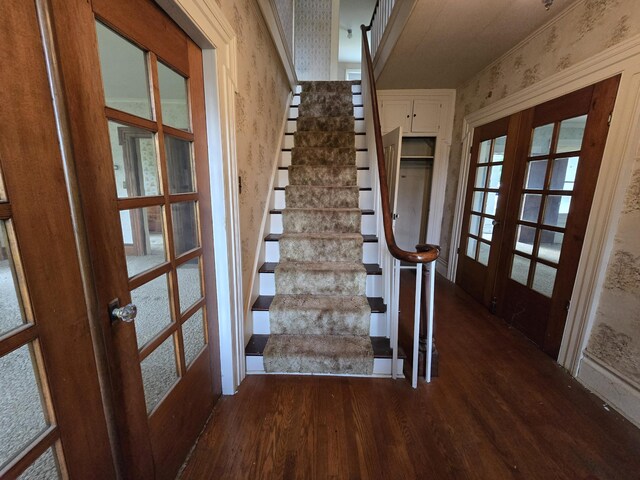 103 S Railroad St, Allen, MI 49227 - stairs with french doors, wallpapered walls, and wood finished floors