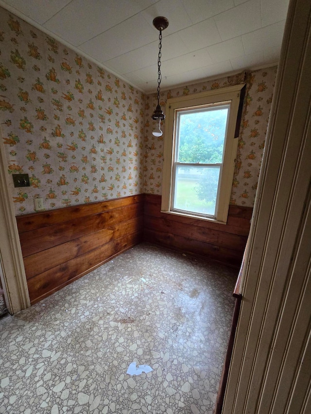 unfurnished dining area with wooden walls