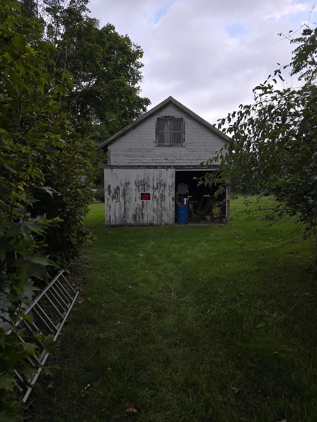 exterior space featuring an outbuilding and a lawn