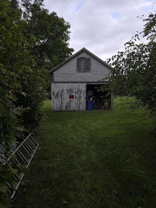 103 S Railroad St, Allen, MI 49227 - view of side of home featuring a yard and an outdoor structure