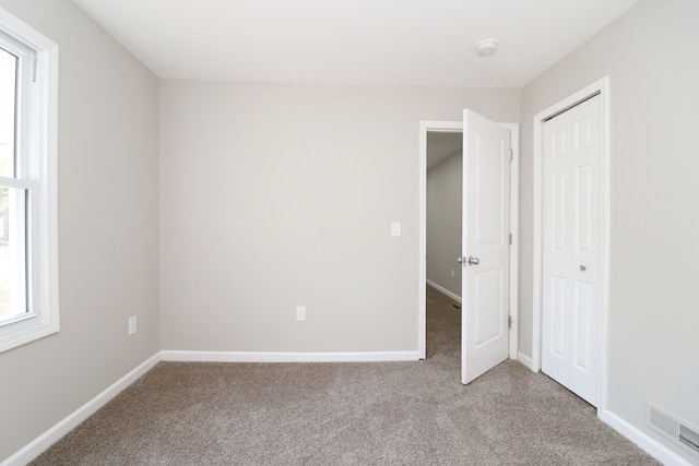 unfurnished bedroom with carpet floors