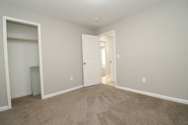 unfurnished bedroom featuring a closet and carpet floors