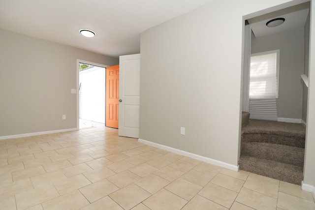 empty room with plenty of natural light and light tile patterned floors