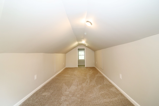 bonus room featuring light carpet and lofted ceiling