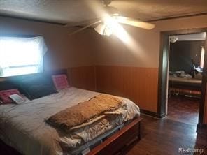 7603 Kentucky St, Dearborn, MI 48126 - bedroom featuring dark wood-style flooring, wainscoting, and a ceiling fan