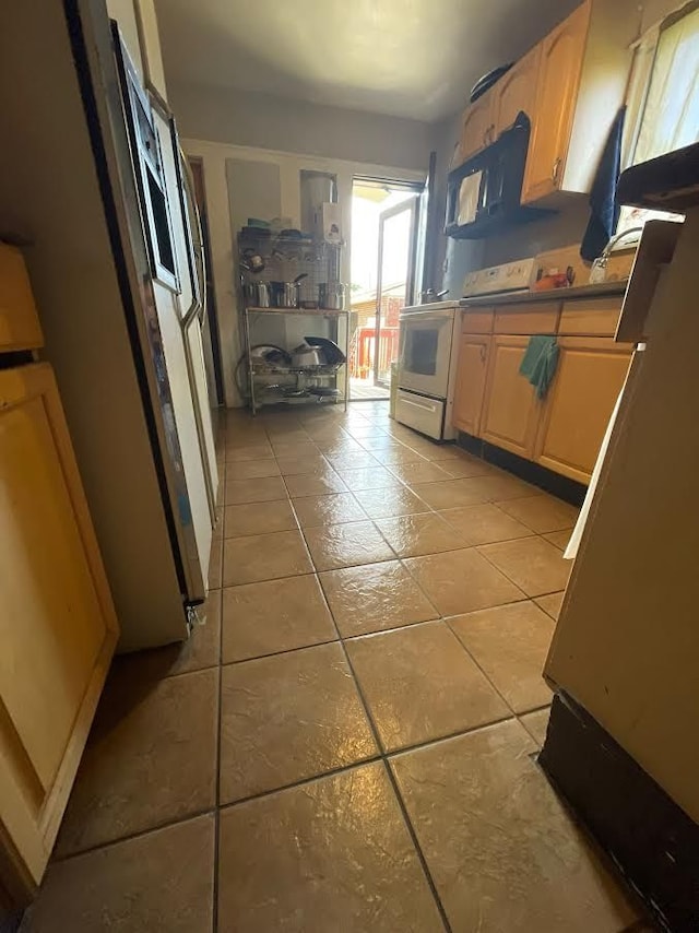 7603 Kentucky St, Dearborn, MI 48126 - kitchen featuring light tile patterned floors, fridge, electric stove, and light brown cabinetry