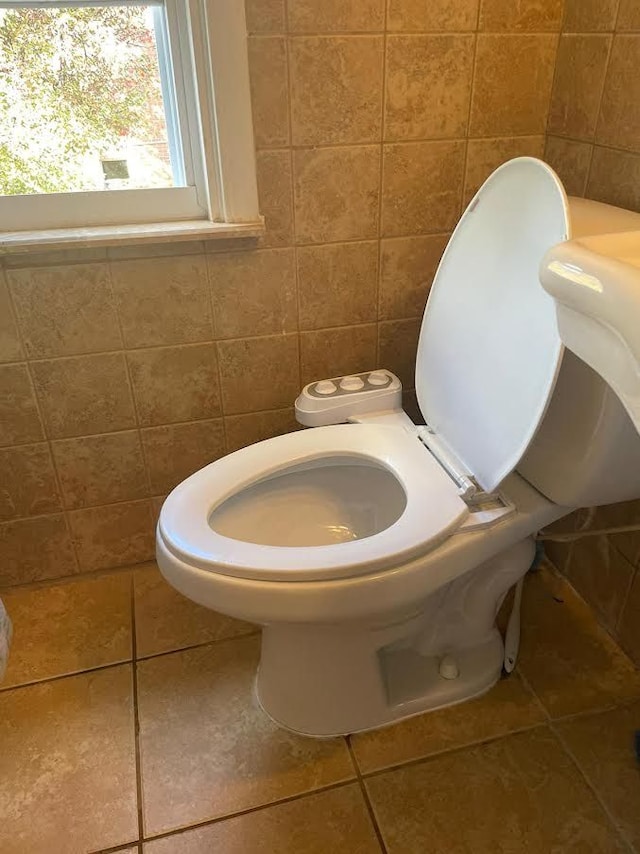7603 Kentucky St, Dearborn, MI 48126 - bathroom with tile walls, toilet, and tile patterned flooring