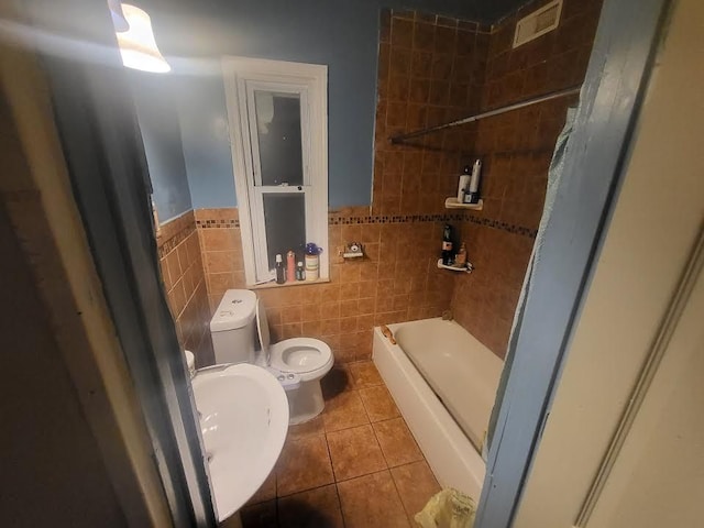 7603 Kentucky St, Dearborn, MI 48126 - bathroom with toilet, tile patterned floors, tile walls, a sink, and tub / shower combination