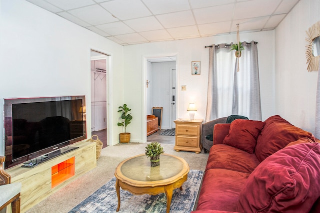 living room with a drop ceiling