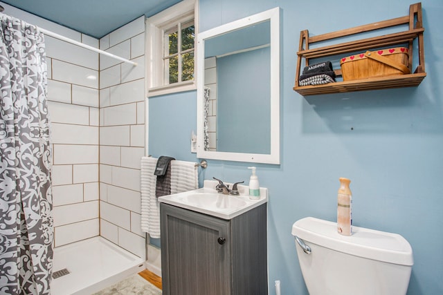 bathroom featuring vanity, toilet, and curtained shower