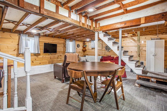 dining area featuring wood walls