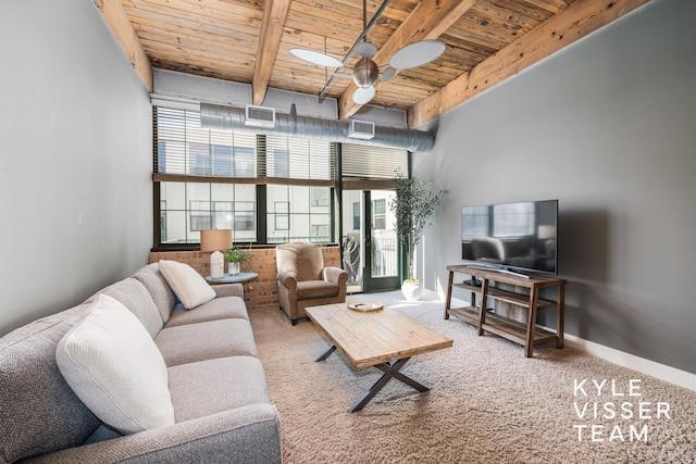 living room with ceiling fan, beamed ceiling, carpet floors, and wood ceiling