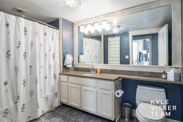 bathroom featuring tile patterned floors, vanity, and toilet