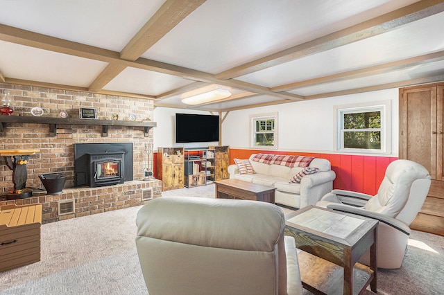 living room featuring a wood stove, beamed ceiling, and coffered ceiling